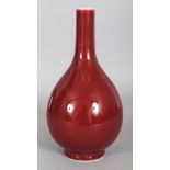 A CHINESE COPPER-RED PORCELAIN BOTTLE VASE, the base with a six-character Qianlong mark, 9.75in