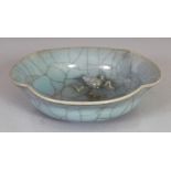 AN UNUSUAL ORIENTAL CELADON CRACKLEGLAZE PETAL-LOBED PORCELAIN BOWL, its interior moulded with a