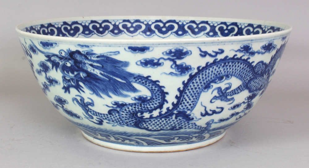 A GOOD LARGE 19TH CENTURY CHINESE BLUE & WHITE PORCELAIN DRAGON BOWL, the base with a six-