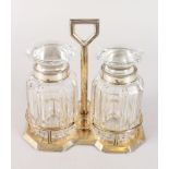 A PAIR OF CUT GLASS BOTTLES with silver bands in a stand.
