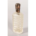 A CUT GLASS SCENT BOTTLE with silver top with key pattern engraving. 3.25ins.