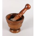 A TURNED WOOD PESTLE AND MORTAR. 4.5ins diameter.