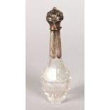 A CUT GLASS SCENT BOTTLE with silver top with key pattern engraving. 4.5ins.