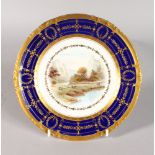 A ROYAL CROWN DERBY PLATE with raised gilt and cobalt blue border painted with Near Tissington