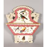 A 19TH CENTURY COALPORT LETTER RACK painted with birds and moths surrounded by a pink scale border.