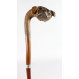 A WALKING STICK WITH DOG HEAD HANDLE.