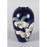 A ROYAL COPENHAGEN RICH BLUE GROUND VASE, decorated with three irises. No. 886 47-7. Mark in blue.