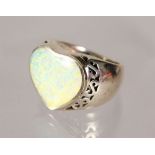 A SILVER HEART SHAPED OPAL RING.