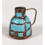 A SMALL ISLAMIC ENAMEL AND COPPER JUG with calligraphy.
