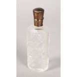 A CUT GLASS SCENT BOTTLE with silver top with key pattern engraving. 3.25ins.