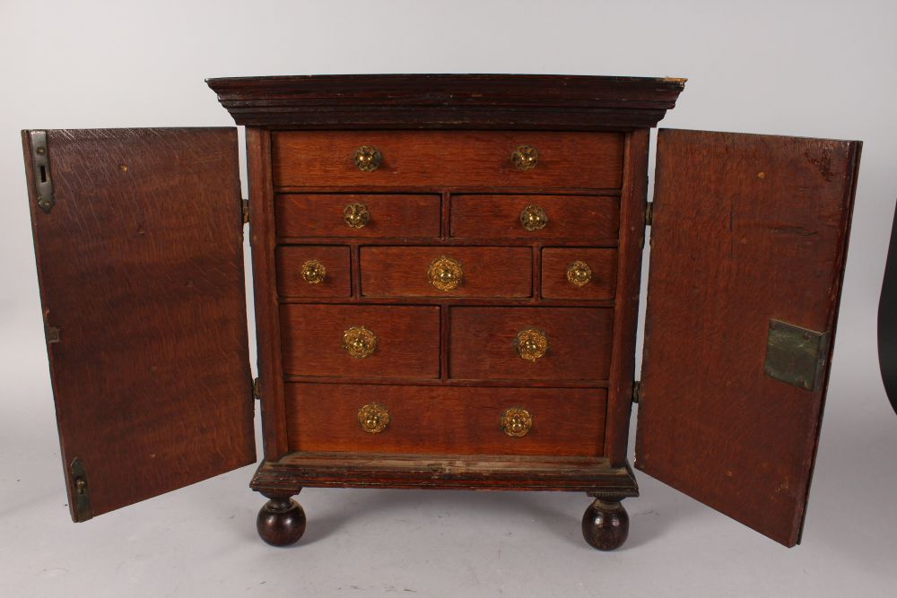 A GOOD 18TH CENTURY OAK APPRENTICES CUPBOARD, with a pair of double doors enclosing drawers, with - Image 2 of 4