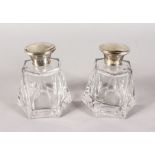 A PAIR OF SCENT BOTTLES AND SILVER STOPPER.