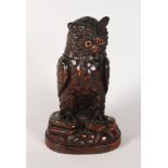 A BLACK FOREST OWL TOBACCO BOX, with lift off head and glass eyes. 12ins high.