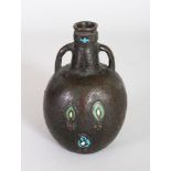 AN EARLY EASTERN BRONZE TWO HANDLED VASE with enamel motifs. 5.5ins high.