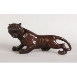 A JAPANESE BRONZE MODEL OF A TIGER. 12ins long.