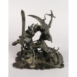 A 20TH CENTURY BRONZE GROUP OF MYTHOLOGICAL BEASTS IN BATTLE. 6ins wide.