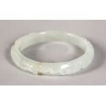 A CARVED WHITE JADE BANGLE.