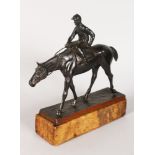 A GOOD BRONZE HORSE AND JOCKEY on a marble base. 10ins high overall.