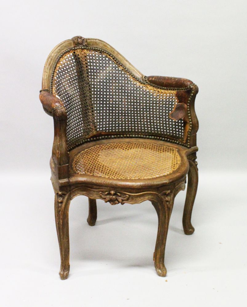 AN 18TH CENTURY FRENCH WALNUT CANE CORNER CHAIR.