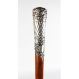 A WALKING STICK with carved SILVER HANDLE.