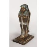 A PAINTED COLD CAST MUMMY, which opens to reveal a nude young lady. 9ins high.