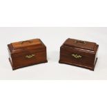 A NEAR PAIR OF GEORGE III MAHOGANY TEA CADDIES, with brass handles and escutcheons, lift up tops, on