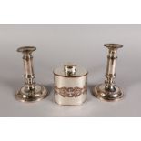 A PAIR OF TELESCOPIC CANDLESTICKS and A TEA CADDY.