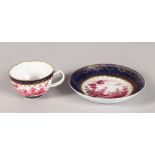 AN 18TH CENTURY DOCCIA TEA CUP AND SAUCER with delicate handle painted with puce landscapes, for a