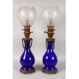 A GOOD PAIR OF 19TH CENTURY FRENCH BLUE GLASS LAMPS with metal mounts and bases, with superb
