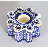 AN ISLAMIC BLUE AND WHITE PORCELAIN INKWELL.