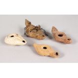 FOUR ROMAN TERRACOTTA OIL LAMPS.