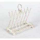 A PLATED "GOLF" TOAST RACK with seven pairs of clubs and balls.