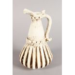 AN UNUSUAL POTTERY WHITE JUG. 9.5ins high.