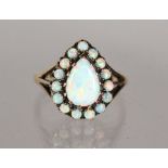 A GOOD 9CT GOLD PEAR SHAPE GILSON OPAL CLUSTER RING.