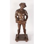 A LARGE BRONZE OF A YOUNG MAN, dressed in Lincoln green on a rectangular base. 29ins high.