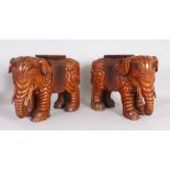 A PAIR OF EASTERN CARVED WOOD ELEPHANT SEATS. 1ft 6ins long x 1ft 1ins high.