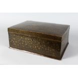AN ISLAMIC BRASS INLAID BOX AND COVER with hinged lid. 1ft 2ins wide.