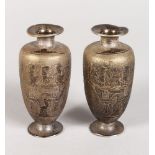 A SMALL PAIR OF EGYPTIAN METAL VASES. 3ins high.