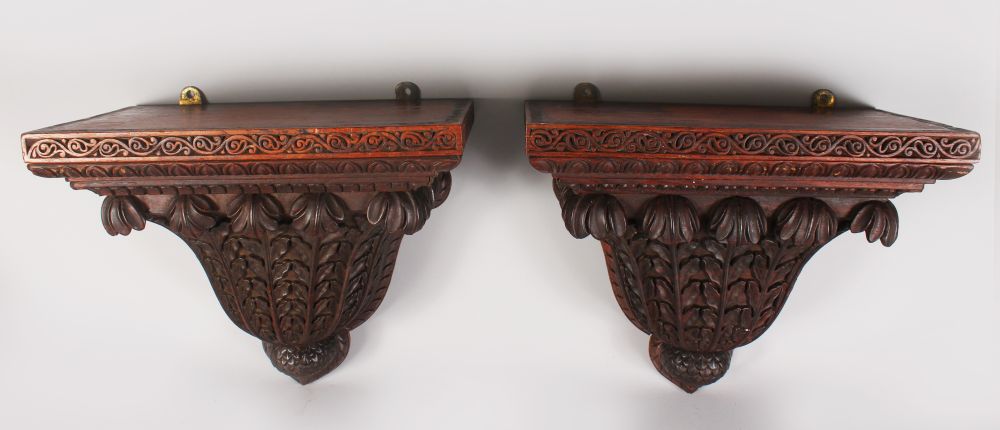 A GOOD PAIR OF CARVED WOOD WALL BRACKETS of ISLAMIC FORM. 1ft 5ins long, 1ft 3ins high.