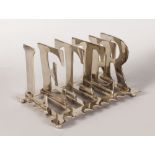 A LARGE TOAST RACK formed with the "LETTERS". 8ins long.