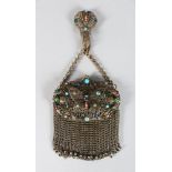 A CHAIN EVENING BAG with coloured stones.