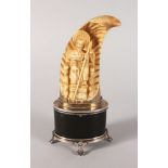 A RARE 19TH CENTURY WHALES TOOTH, carved with a man on a throne holding a staff and mounted on