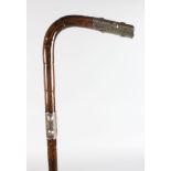 A WALKING STICK with carved SILVER HANDLE.