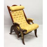 AN UNUSUAL MAHOGANY AND BRASS RECLINING CHAIR with leather cushion.