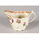 A WORCESTER MOULDED CREAM JUG painted with flowers.