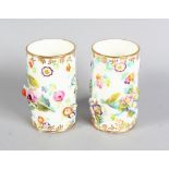 A PAIR OF 19TH CENTURY MINTON FLOWER ENCRUSTED SPILL VASES. 3.5ins high.