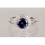 AN 18CT WHITE GOLD, TANZANITE AND DIAMOND HALO STYLE RING, 1.6CT.