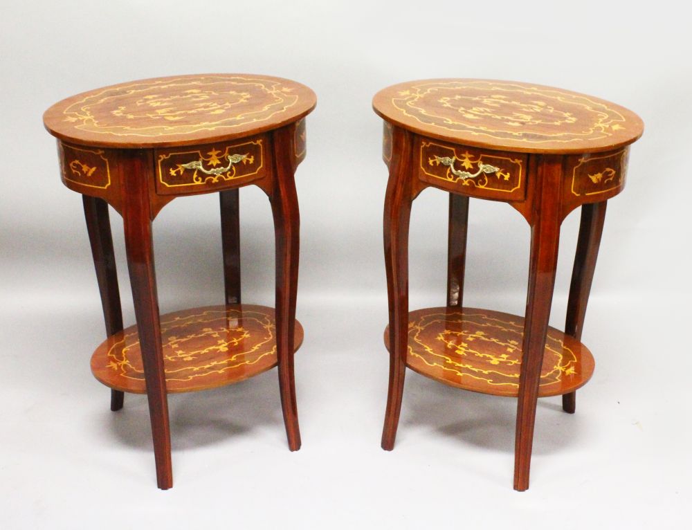 A PAIR OF FRENCH STYLE OVAL SIDE TABLES, with inlaid decoration, a single drawer on shaped legs