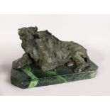 AN UNUSUAL ABSTRACT BRONZE OF A RECUMBENT COW, on a rectangular marble base. 1ft 6ins long.