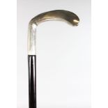 A WALKING STICK with carved SILVER HANDLE.